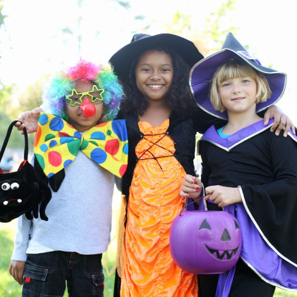 three kids dressed up in halloween costumes 